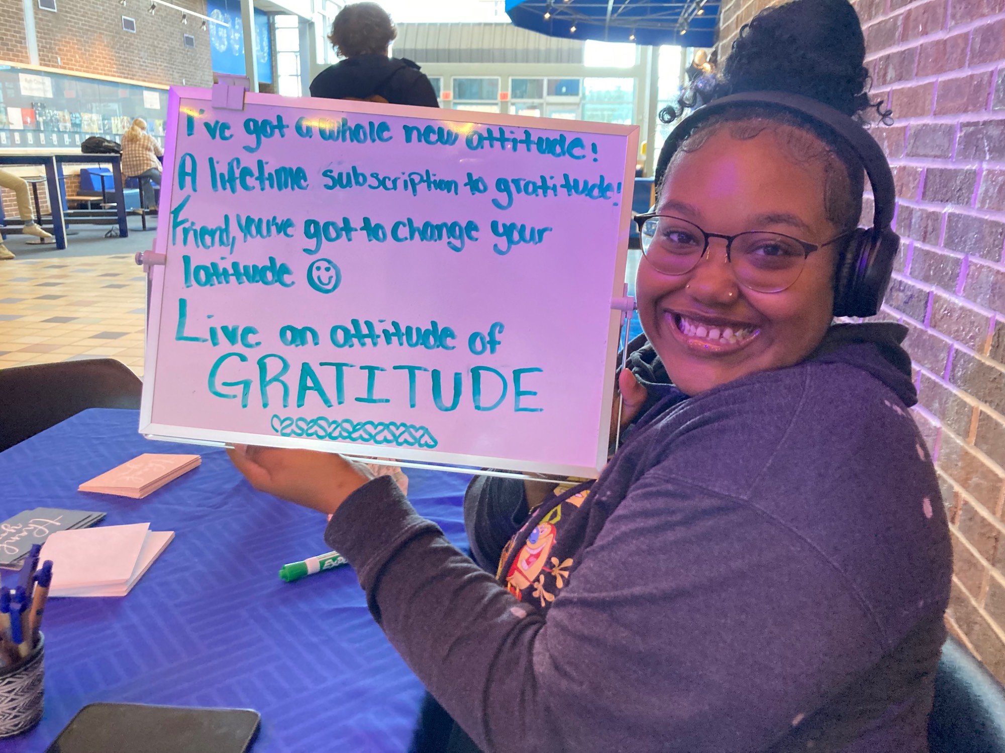 Chloe with a sign of gratitude